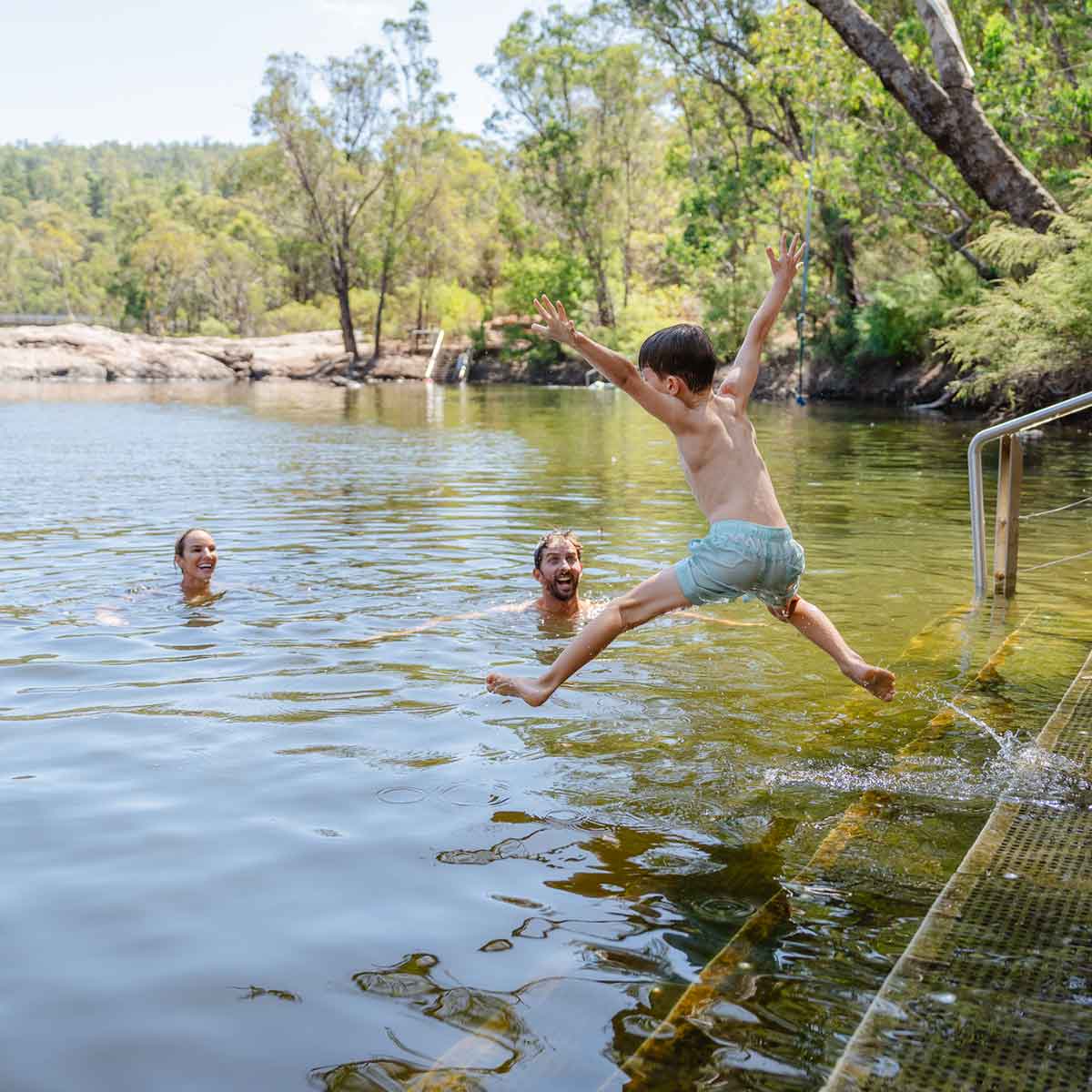 Family swimming at Dwaarlindjirraap in Lane Poole Reserve Dwellingup